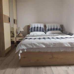 a bedroom with a bed with blue and white pillows at Tiny House Veronia in Ohrid