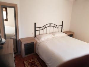 a bedroom with a large bed and a mirror at Casa Marqueso in Figuerola de Orcau
