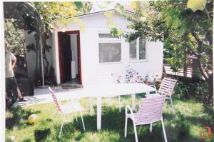 a table and chairs in front of a house at Tiny House Veronia in Ohrid