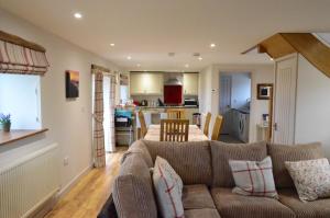 a living room with a couch and a kitchen at The Gallops in Cardiff