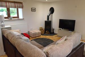 a living room with a couch and a fire place at The Gallops in Cardiff