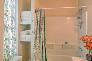 a bathroom with a shower curtain and a tub at Saratoga Springs Apt - Walk to Town and Race Track! in Saratoga Springs +16 photos