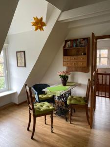 a dining room with a table and two chairs at Landhaus Kiesow in Suderburg
