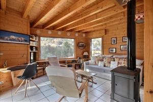 a log cabin living room with a wood stove at CHALET WIFI - LE BIOT - 8 PERSONNES - CHALET MORAND in Le Biot