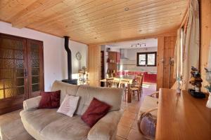 a living room with a couch and a table at CHALET AVEC VUE DEGAGEE - SAINT JEAN D'AULPS - 8 PERSONNES - MOUILLETTES in Saint-Jean-d'Aulps