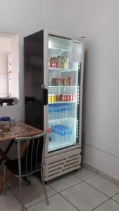 a refrigerator with its door open with drinks inside at Hotel Nove De Julho in Marília