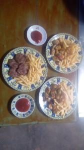 four plates of food on a table with pasta at Chez Bilal Ait Ben Haddou in Ouarzazate