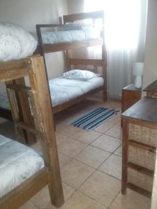a room with two bunk beds and a table at Fatties and Monies Guesthouse in Sabie