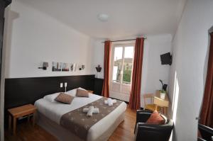 Un ou plusieurs lits dans un hébergement de l'établissement Hotel Cote Basque