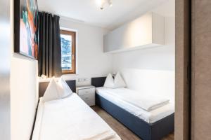 Posteľ alebo postele v izbe v ubytovaní Kaprun Apartments