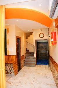 a hallway of a building with a door and stairs at Hotel Nest N Rest - Mumbai in Mumbai