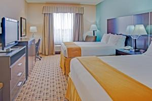 Postel nebo postele na pokoji v ubytování Aspen Grand Hotel Houston
