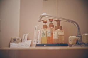 two bottles of soap are sitting on a sink at Apricot Pension in Hakuba +111 photos
