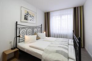 Posteľ alebo postele v izbe v ubytovaní Kaprun Apartments