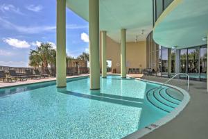 a swimming pool with blue water in a building at Beachfront Bliss on Dauphin Island with Pool Access! in Dauphin Island
