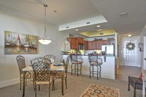 a kitchen and dining room with a table and chairs at Beachfront Bliss on Dauphin Island with Pool Access! in Dauphin Island