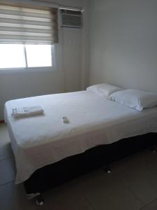 A bed or beds in a room at Apartamento Luxo Barra