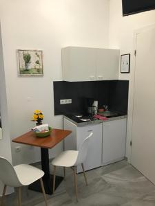 uma pequena cozinha com uma mesa e uma mesa e cadeiras em Saralo Apartments 1050 em Viena