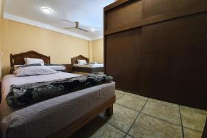 Postel nebo postele na pokoji v ubytování Hotel Colonos Los Cabos