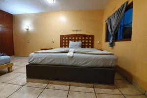 Postel nebo postele na pokoji v ubytování Hotel Colonos Los Cabos