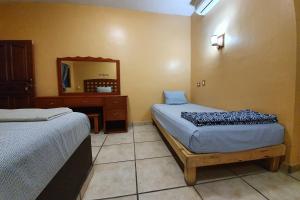 Postel nebo postele na pokoji v ubytování Hotel Colonos Los Cabos