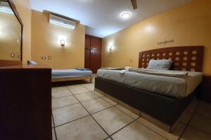 Postel nebo postele na pokoji v ubytování Hotel Colonos Los Cabos