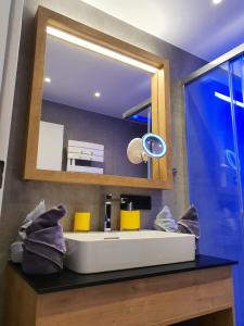 a bathroom with a sink and a mirror at Apartment Leontina - with Air Conditioning and Summer Card in Kaprun