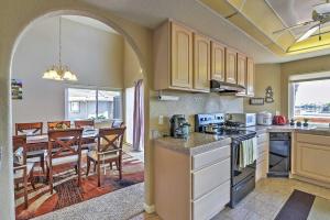 a kitchen and dining room with an archway and a table at Waterfront Discovery Bay Home Outdoor Bar and Dock in Discovery Bay