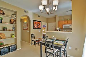 a kitchen and dining room with a table and chairs at Condo with Pool Access Less Than 4 Mi to Bellair Golf Club! in Phoenix