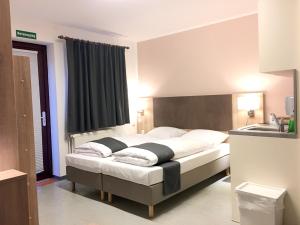 Postel nebo postele na pokoji v ubytování Hana Aparthotel