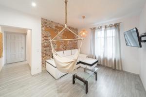 a living room with a swing and a chair at Around the World Vision Apartment - Centrum in Opole