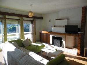 a living room with a couch and a fireplace at T3 em Sever do Vouga in Sever do Vouga