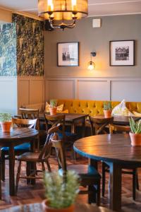 a restaurant with tables and chairs and a couch at The Black Boy in Oxford