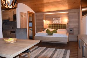 a small bedroom with a bed in a kitchen at Gästehaus Emberger in Wagrain