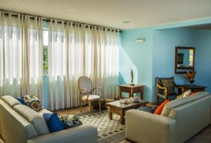 a living room with two couches and a table at Farol de Itapuã Praia Hotel in Salvador