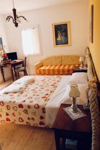 a bedroom with a bed and a table and a desk at Red Fenice in San Donà di Piave