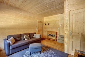 - un salon avec un canapé dans une pièce en bois dans l'établissement CHALET SAUNA AU PIED DES PISTES - SAINT JEAN D'AULPS STATION - 14 PERSONNES - CHALET PHOENIX, à Saint-Jean-dʼAulps