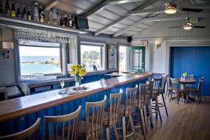 a bar in a restaurant with blue walls and chairs at Little River Inn in Little River