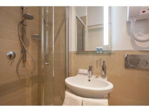 a bathroom with a toilet and a sink and a shower at Window On Rome in Rome