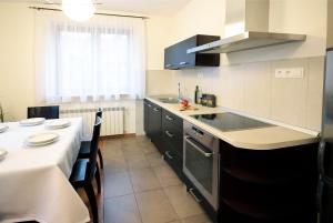 a kitchen with a table and a counter top at Apartament Łukaszówki in Zakopane