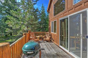 a deck with a grill and chairs on a cabin at Bright Klamath Falls Cabin with Deck and Mtn Views! in Klamath Falls