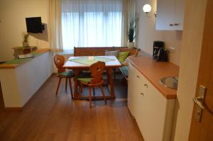 a small kitchen with a table and a living room at Haus Frey in Sankt Johann im Pongau