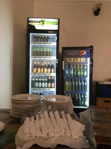 a refrigerator filled with lots of bottles of soda at Dream Palace Hotel Mbale in Mbale