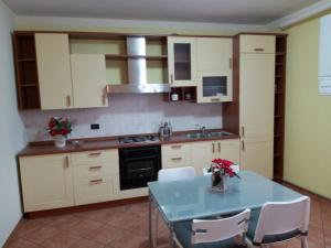a kitchen with a blue table and white cabinets at CASA LAGHETTO in Bovegno