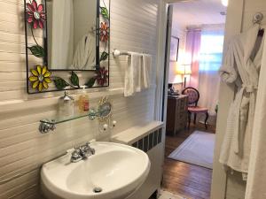 a bathroom with a sink and a mirror at Oakland Cottage Bed and Breakfast in Asheville +51 photos