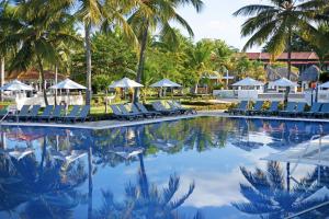 a pool at the resort with chairs and palm trees at Catalonia Bayahibe - All Inclusive in Bayahibe +66 photos