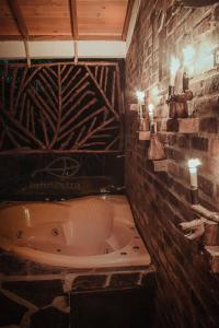 a bathroom with a bath tub in a brick wall at La Finestra Spa Hotel Boutique in La Vega