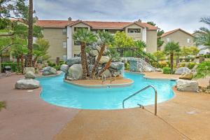 a swimming pool with a water slide in a resort at Las Vegas Condo Patio, Pool, Gym about 1 Mi to Strip in Las Vegas