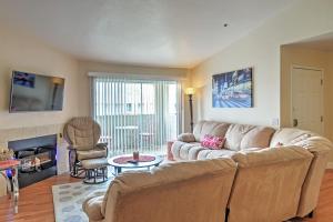 a living room with a couch and a fireplace at Las Vegas Condo with Patio, Pool, Gym about 1 Mi to Strip in Las Vegas