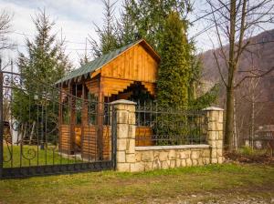 a wooden gazebo with a black fence at Prut in Yaremche